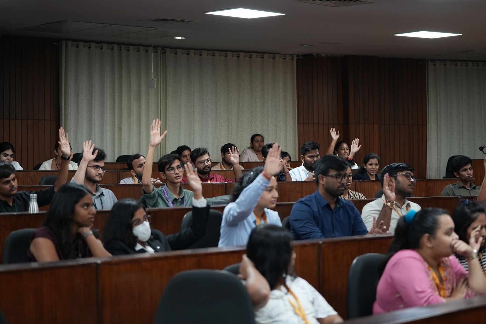 Students raising their hands during Anu Bulusu's session at Alliance University